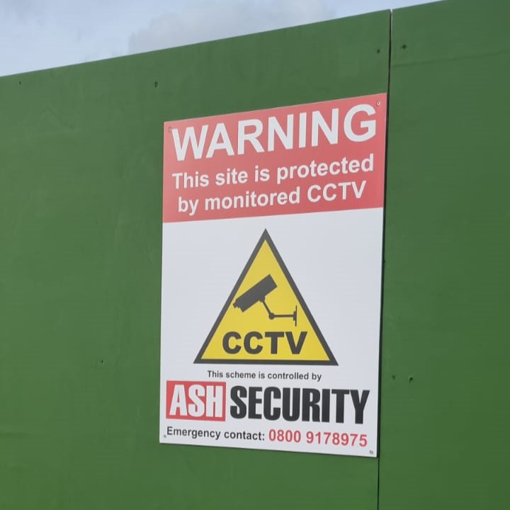 Warning sign indicating monitored CCTV protection at a construction site, featuring a CCTV camera graphic and ASH Security branding, emphasizing security measures against theft and vandalism.